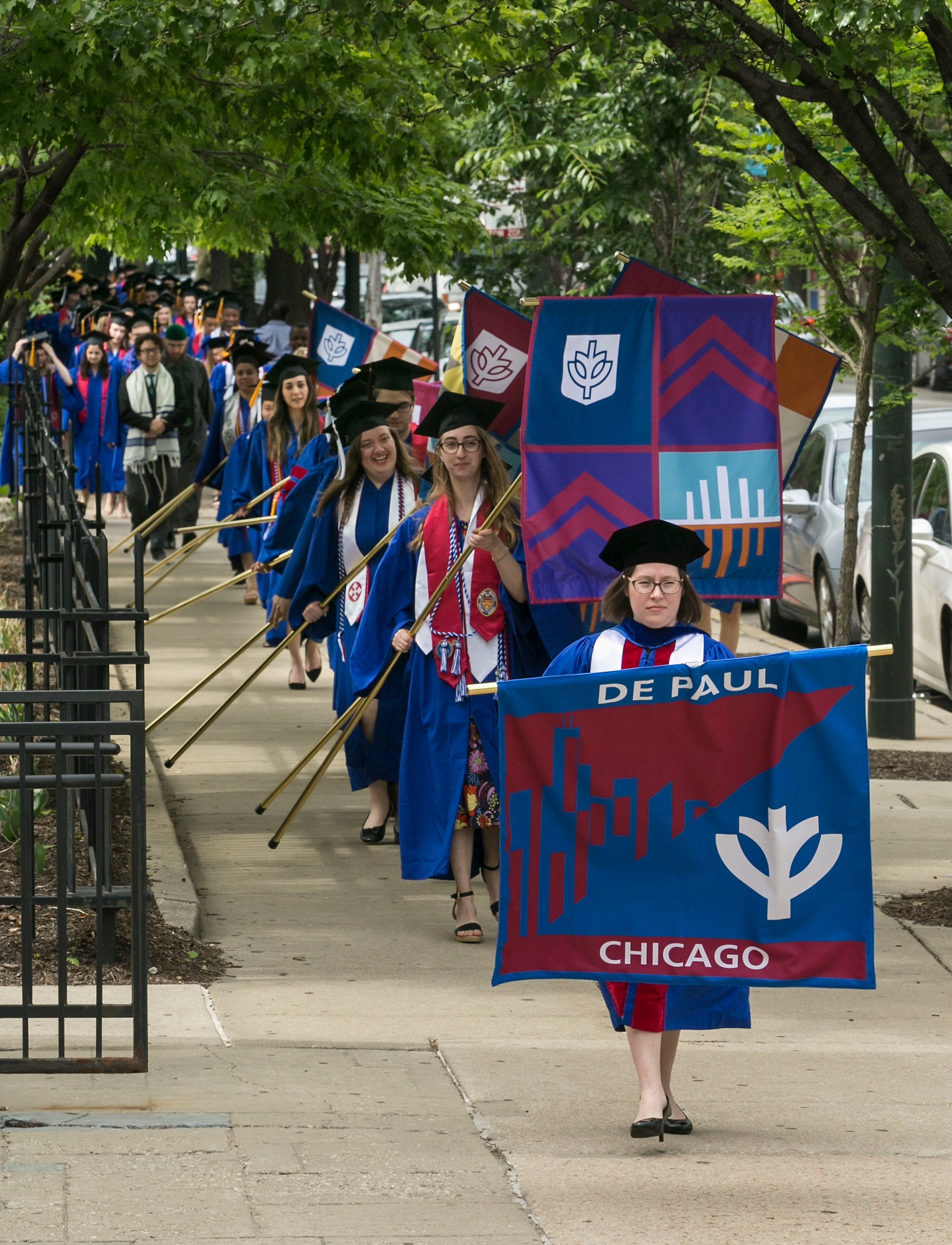 Carrying DePaul's school and college banners, students make their way into the St. Vincent de Paul Parish Church for the annual Baccalaureate Mass. (DePaul University/Jamie Moncrief)